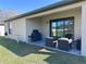 Covered back patio with outdoor furniture and grill overlooking the backyard at 12403 Coralbean Ct, New Port Richey, FL 34654