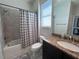 Bathroom featuring tub/shower combination with granite countertop vanity at 12403 Coralbean Ct, New Port Richey, FL 34654