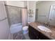 Bathroom with granite countertops, decorative shelving, a bathtub, and tiled walls at 12403 Coralbean Ct, New Port Richey, FL 34654