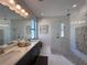 Stylish bathroom with double vanity, glass-enclosed shower, and modern design touches at 12403 Coralbean Ct, New Port Richey, FL 34654