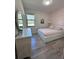 Bedroom featuring wood-look flooring, modern accents, and a bright window at 12403 Coralbean Ct, New Port Richey, FL 34654