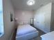 Bedroom featuring wood-look flooring, modern accents, and a bright window at 12403 Coralbean Ct, New Port Richey, FL 34654