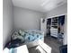 Charming bedroom with a twin bed, closet with organizers, and wood-look flooring at 12403 Coralbean Ct, New Port Richey, FL 34654