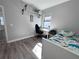 Bright bedroom features a twin bed, desk, wood floors, and plenty of natural light at 12403 Coralbean Ct, New Port Richey, FL 34654