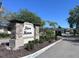Stone sign for Rose Haven community entrance amidst landscaping and palm trees at 12403 Coralbean Ct, New Port Richey, FL 34654