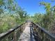 Wooden dock and walkway providing serene waterfront views and nature observation at 12403 Coralbean Ct, New Port Richey, FL 34654