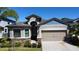 Charming one-story home with a two-car garage, and landscaped yard at 12403 Coralbean Ct, New Port Richey, FL 34654