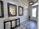 Welcoming foyer with wood-look tile flooring, statement mirrors, and front door view at 12403 Coralbean Ct, New Port Richey, FL 34654