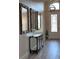 Elegant foyer featuring wood-look tile flooring and decorative mirrors at 12403 Coralbean Ct, New Port Richey, FL 34654