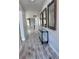 Entryway with stylish mirrors, decor, and wood-look tile leading into living areas at 12403 Coralbean Ct, New Port Richey, FL 34654