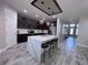 Beautiful kitchen featuring stainless steel appliances, dark cabinetry, and a large marble island at 12403 Coralbean Ct, New Port Richey, FL 34654