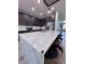 Modern kitchen with a large marble island, sleek appliances, and dark wood cabinets at 12403 Coralbean Ct, New Port Richey, FL 34654