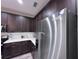 Kitchen features stainless steel appliances, rich wood cabinetry, and white countertops at 12403 Coralbean Ct, New Port Richey, FL 34654