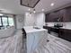 Open-concept kitchen with marble island, dark cabinets, and easy access to the living room at 12403 Coralbean Ct, New Port Richey, FL 34654