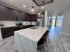 Kitchen island with quartz countertop, seating, pendant lights, and stainless steel appliances at 12403 Coralbean Ct, New Port Richey, FL 34654