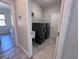Laundry room featuring side-by-side black washer and dryer, and utility sink at 12403 Coralbean Ct, New Port Richey, FL 34654