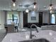 Open-concept living and dining area with modern lighting and stylish decor at 12403 Coralbean Ct, New Port Richey, FL 34654