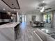 Open floor plan with kitchen island, dining area, and living room at 12403 Coralbean Ct, New Port Richey, FL 34654