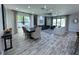 Open-concept living and dining area with abundant natural light and stylish decor at 12403 Coralbean Ct, New Port Richey, FL 34654