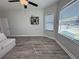 Spacious living room with natural light, ceiling fan, and attractive plank flooring at 12403 Coralbean Ct, New Port Richey, FL 34654