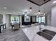 Open-concept living and dining areas featuring modern pendant lights at 12403 Coralbean Ct, New Port Richey, FL 34654