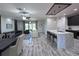 Open living and kitchen area with modern finishes and ample seating at 12403 Coralbean Ct, New Port Richey, FL 34654