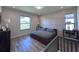 Cozy bedroom with laminate flooring, decorative wall accents, and a view outside at 12403 Coralbean Ct, New Port Richey, FL 34654