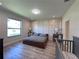 Bedroom showcasing laminate flooring and decorative wall with large sunny window at 12403 Coralbean Ct, New Port Richey, FL 34654