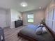 Spacious bedroom features a large window, laminate flooring, and decorative touches at 12403 Coralbean Ct, New Port Richey, FL 34654