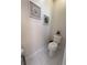 Neat powder room with neutral walls, a modern toilet, and contemporary decor at 12403 Coralbean Ct, New Port Richey, FL 34654
