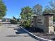 Rose Haven community sign with stone accents and well-manicured landscaping at 12403 Coralbean Ct, New Port Richey, FL 34654