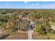 Aerial view of a home with a large yard and mature landscaping at 1281 Bolander Ave, Spring Hill, FL 34609