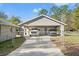 View of garage with an open car port and a gated entrance; two vehicles are parked inside at 1281 Bolander Ave, Spring Hill, FL 34609