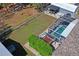 An aerial view of a beautiful backyard featuring pool, a shed, and green space at 13045 Marbled Godwit Rd, Weeki Wachee, FL 34614