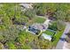 Overhead view of a fenced backyard with a pool, detached storage shed, and ample green space at 13045 Marbled Godwit Rd, Weeki Wachee, FL 34614