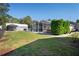 Expansive backyard featuring well-maintained lawn, screen enclosed pool and spa, and a garage at 13045 Marbled Godwit Rd, Weeki Wachee, FL 34614