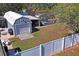 Large fenced backyard with shed, greenhouse, mature trees, landscaping, and plenty of grassy space for recreation at 13045 Marbled Godwit Rd, Weeki Wachee, FL 34614