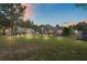 Spacious backyard featuring a garage, patio set, screen enclosed pool, and a well-maintained lawn at 13045 Marbled Godwit Rd, Weeki Wachee, FL 34614