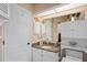 Neutral bathroom with granite countertop, decorative accents, storage cabinet, and tile floors at 13045 Marbled Godwit Rd, Weeki Wachee, FL 34614