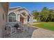 Charming home with columns, brick patio, and lush landscaping, perfect for outdoor enjoyment at 13045 Marbled Godwit Rd, Weeki Wachee, FL 34614