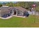 Charming home with a cozy front patio, manicured lawn, and American flag waving in the yard at 13045 Marbled Godwit Rd, Weeki Wachee, FL 34614