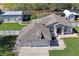 Aerial view of this single-Gathering home featuring a paved patio area and a long driveway at 13045 Marbled Godwit Rd, Weeki Wachee, FL 34614