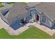 Aerial view of home's entrance with an outdoor patio area perfect for enjoying the Florida sunshine at 13045 Marbled Godwit Rd, Weeki Wachee, FL 34614