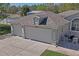 Aerial view of the garage and the outdoor patio that provides a comfortable and stylish outdoor experience at 13045 Marbled Godwit Rd, Weeki Wachee, FL 34614