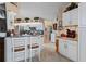 Bright kitchen with stainless steel appliances, white cabinetry and breakfast bar, seamlessly blending style with functionality at 13045 Marbled Godwit Rd, Weeki Wachee, FL 34614