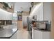 Modern kitchen featuring white cabinetry, stainless steel appliances, and tile flooring at 13045 Marbled Godwit Rd, Weeki Wachee, FL 34614