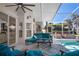 Beautiful screened-in lanai with teal furniture, ceiling fan, and access to the sparkling pool at 13045 Marbled Godwit Rd, Weeki Wachee, FL 34614