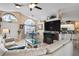 Spacious living room connected to the kitchen and dining area, with a white sectional and tile flooring at 13045 Marbled Godwit Rd, Weeki Wachee, FL 34614