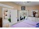 Bright main bedroom with luxury white furnishings and view of backyard pool at 13045 Marbled Godwit Rd, Weeki Wachee, FL 34614