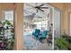 Covered outdoor patio with seating area, ceiling fan, view of the pool and backyard at 13045 Marbled Godwit Rd, Weeki Wachee, FL 34614